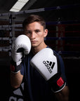 Man wearing boxing gloves for training.