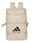 A beige adidas Combat Sports backpack made from cotton canvas, featuring multiple compartments and shoulder straps.