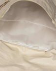 close up of tan backpack showing the inside, empty
