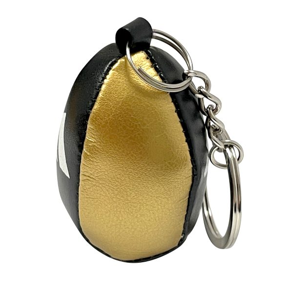 Close up of Adidas Speedball Mini Keychain in black and gold.
