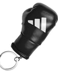 Black leather boxing glove keychain on white background.