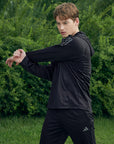 Man in a black jacket from adidas Men's Hydrosuit adiSS23.