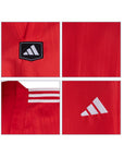 Red sports jersey with Adidas logo and branding on a white background