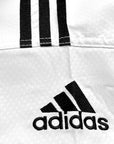 Close-up of a logo on Adidas taekwondo sparring uniform.