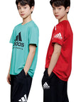 Two boys in adidas youth summer teamwear set against a white background.