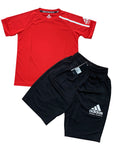 Red shirt and black Adidas shorts.