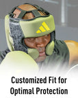 Man wearing boxing helmet for protection.