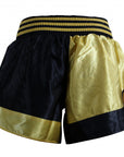 Black and gold Thai boxing shorts.