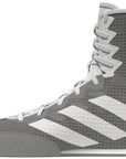Gray Adidas boxing boot with white stripes on a white background