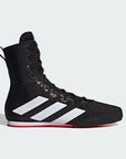 Black Adidas boxing shoe with white stripes on a light gray background