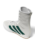 side profile view of white adidas sneaker and green logo on the side