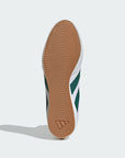 Close-up of a shoe sole with a brown tread pattern on a white background