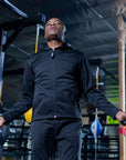 Man in black jacket holding an Adidas skipping rope.