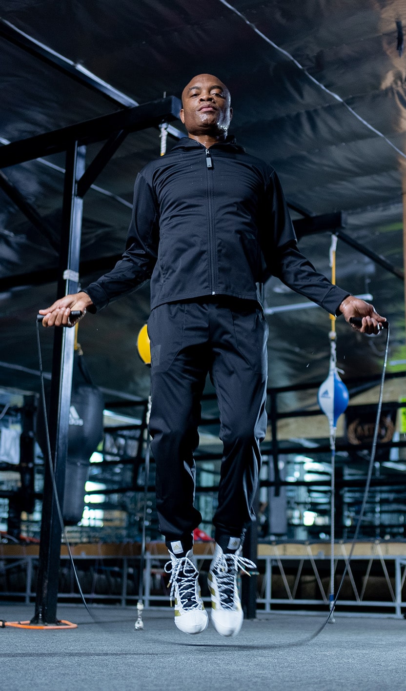 Man jumping rope demonstrating Adidas jump rope in use.