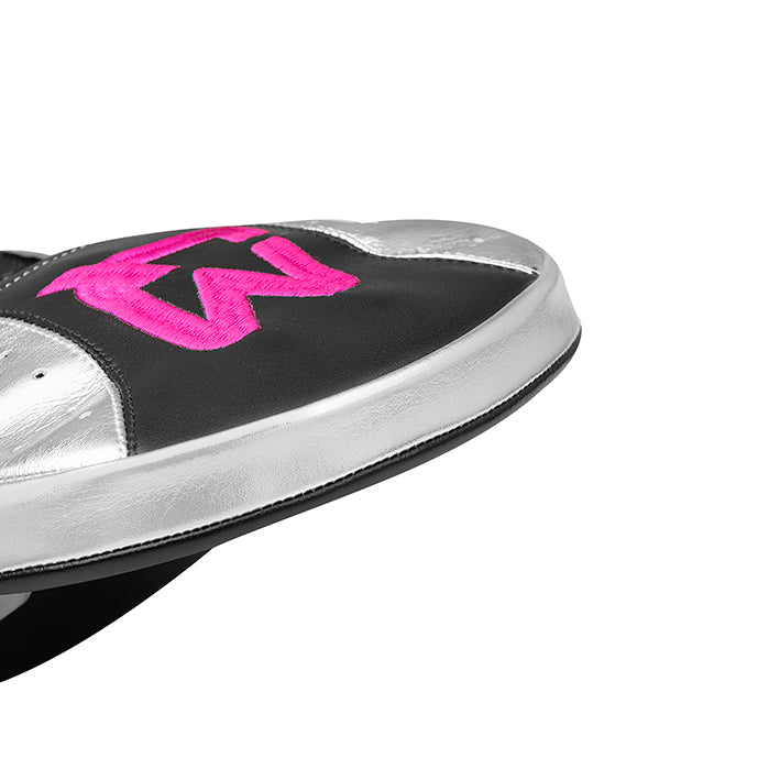 Close-up of a shoe with pink logo on a white background
