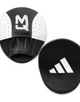 Black and white training pads with MQ and Adidas logos on a white background