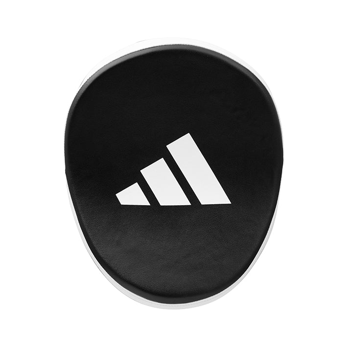 Black circular object with Adidas logo on a white background