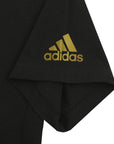 Black shirt with gold logo, close-up view.
