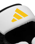 close up of white yellow adidas head gear