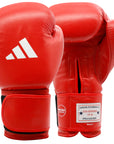 A pair of red Adidas amateur boxing gloves with white Adidas logo, approved by IBA and USA Boxing, with a wide Velcro strap cuff.