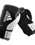 A pair of adidas Hybrid 150 boxing gloves in black and white, 14 oz weight.