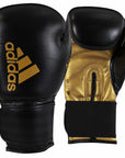 Pair of adidas Hybrid 50 black and gold boxing gloves.