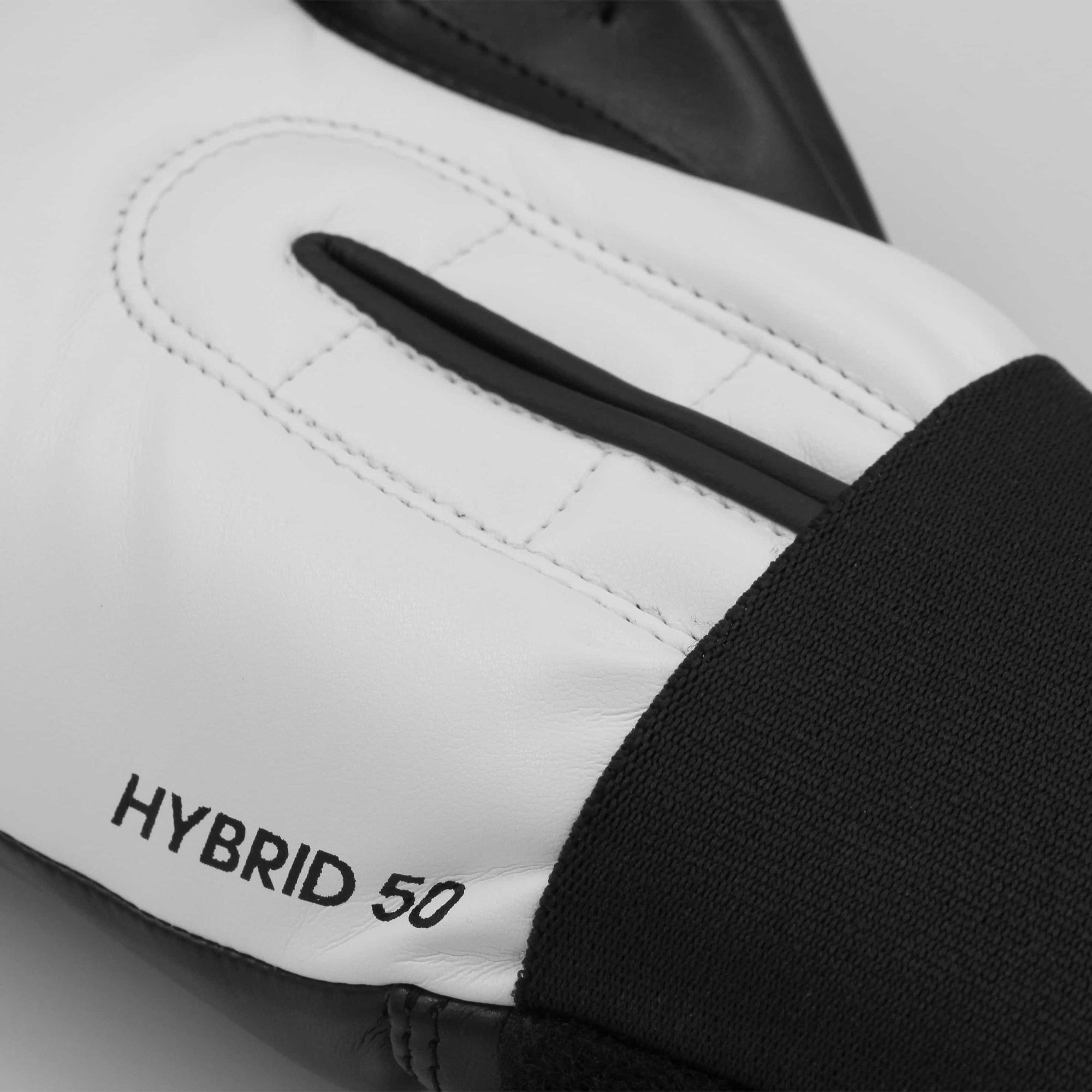 Close-up of adidas Hybrid 50 boxing glove in black and white.