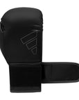 Black Adidas Hybrid 80 boxing glove on white background.