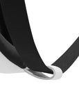 Close-up of a black strap with a white buckle on a white background