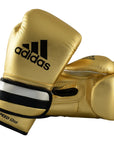Pair of gold Adidas boxing gloves with black details.