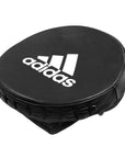 Black round object with adidas logo.