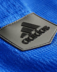 Black logo on blue fabric for Adidas Champion Taekwondo uniform.