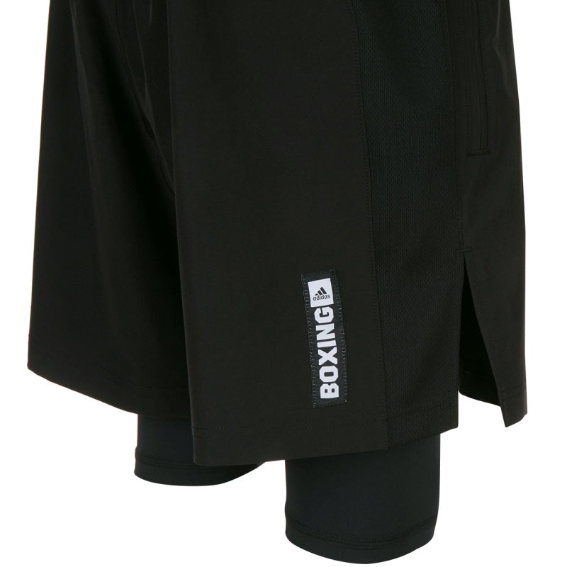 Pair of black Adidas shorts with thigh-length inner lining, size L.