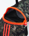 Bag with multiple zippers and camo pattern, Adidas branding.