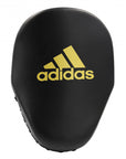 Adidas black focus mitt with yellow logo for boxing training.