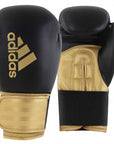 A pair of Adidas Hybrid 100 boxing gloves, black and red, 12 oz weight.