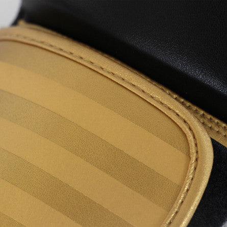 Close up of Adidas Hybrid 100 leather and gold boxing glove.