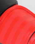 Red boxing glove on a black surface, adidas Hybrid 100 series.