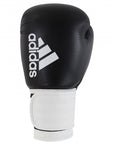A black and white Adidas Hybrid 100 boxing glove, 14 oz weight.