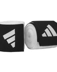 Pair of black and white boxing hand wraps in a roll.