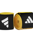 Pair of yellow and black boxing hand wraps in a roll.