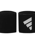 Pair of black boxing wrist wraps in a roll.