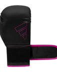 Black and pink Adidas Hybrid 80 boxing glove.