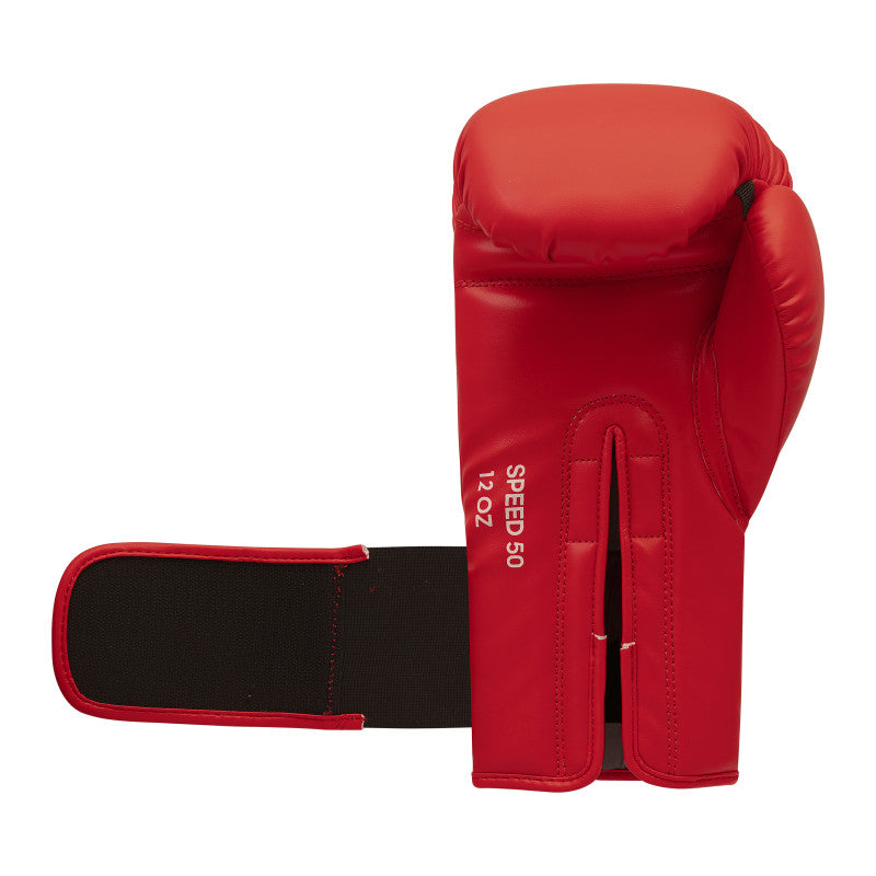 Red boxing glove with a black strap, suitable for training and competitions.