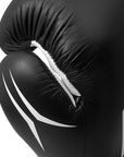 Black boxing glove with white accents on a black background