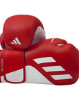 Red boxing gloves with white Adidas logo on a white background