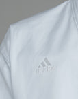 Close-up of white karate uniform by Adidas.