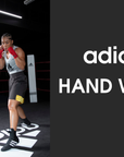 A woman in boxing gloves prepares to spar.