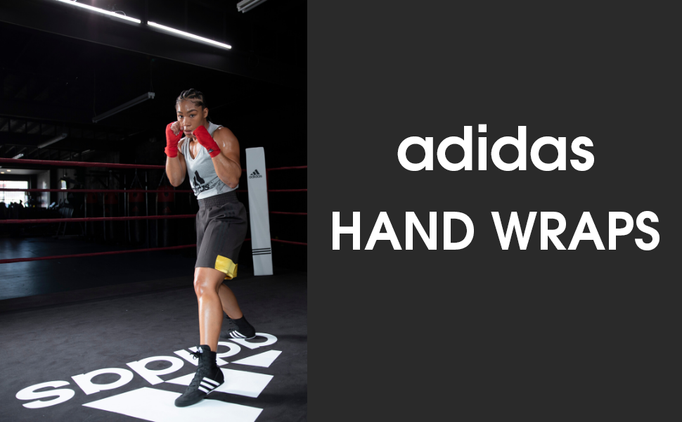 A woman wearing boxing gloves, preparing for a match.