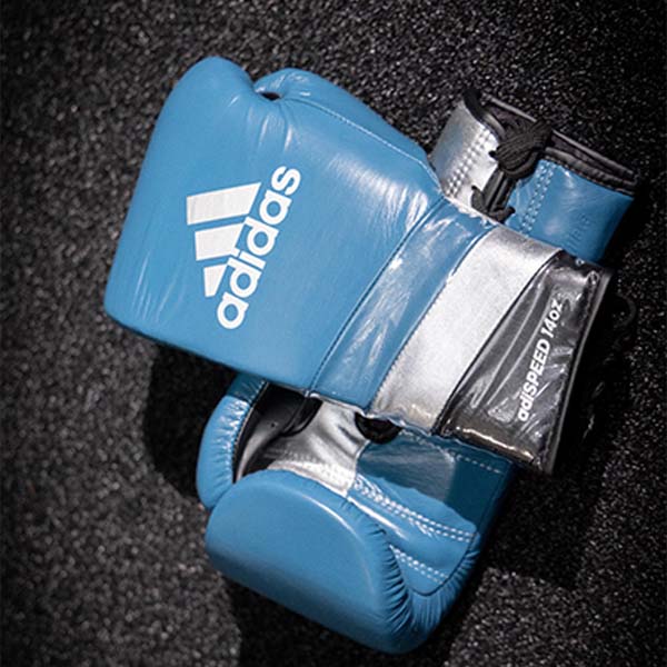 Blue boxing gloves on a black surface, limited edition release.